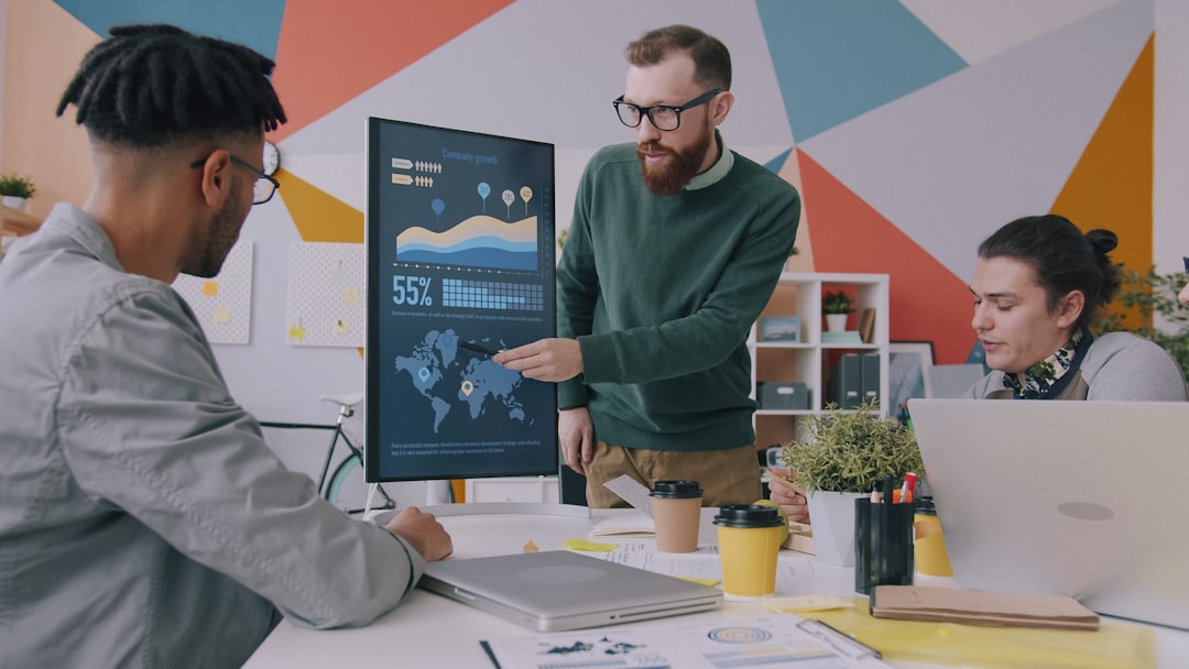 Business team reviewing performance metrics and outsourcing KPIs on a digital display