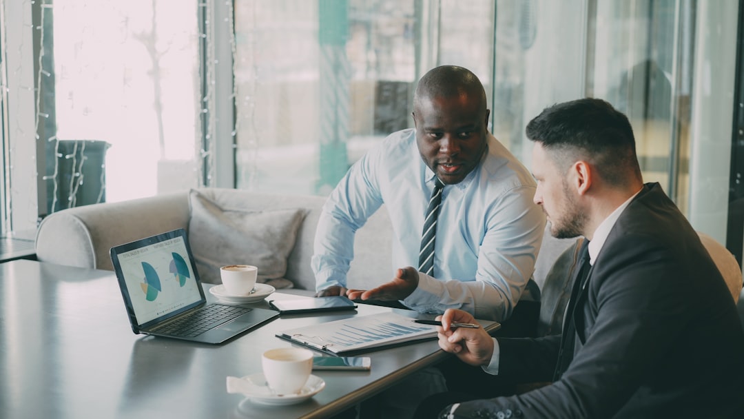 Business leaders reviewing reports and operational performance to decide when an offshore team needs managed services
