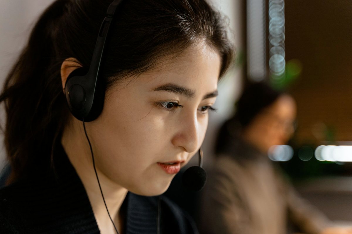 Customer support agent with a headset answering a customer inquiry