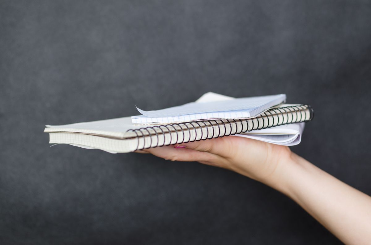 Person holding a notebook