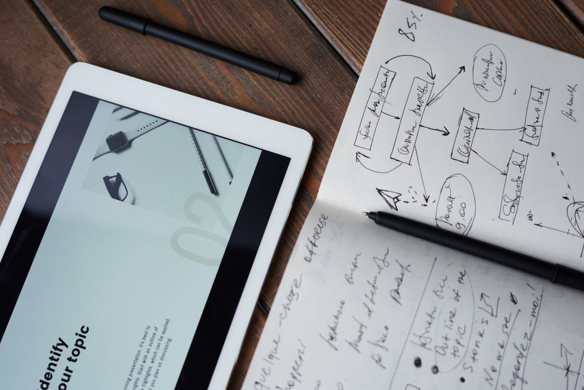 Pen on top of a notebook with a task list