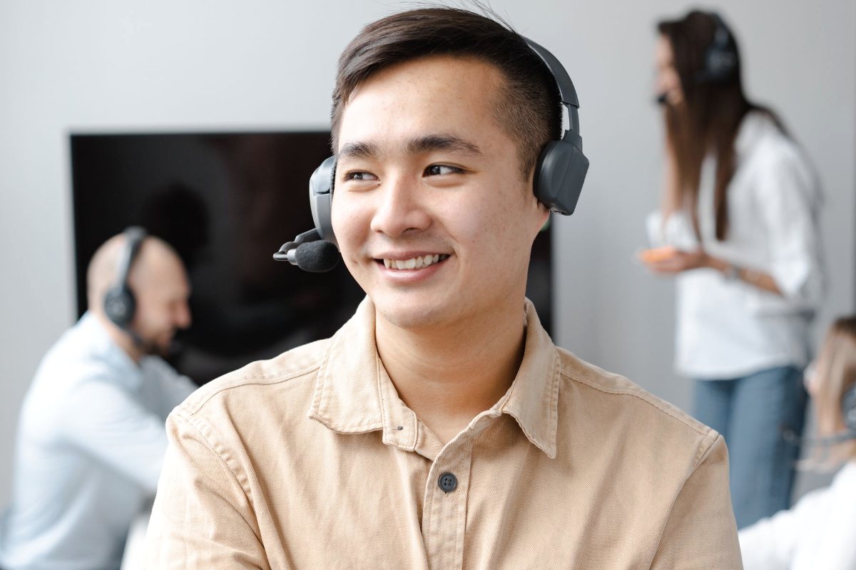 Smiling call center agent wearing a headset at her desk