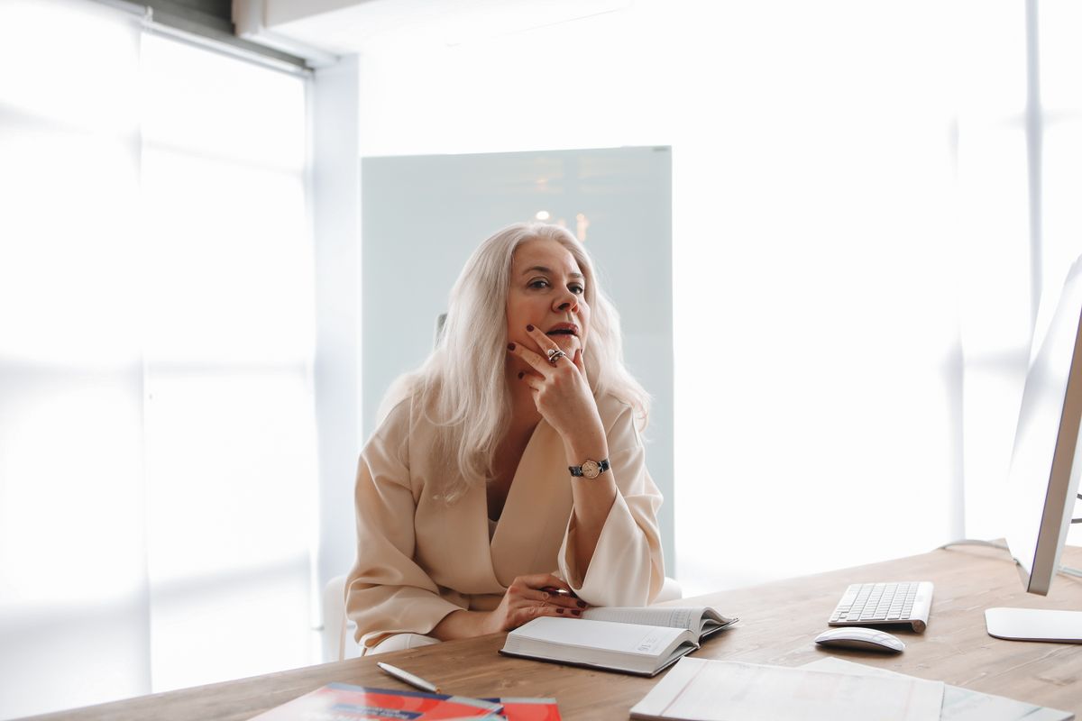 Business owner thinking at a wooden table